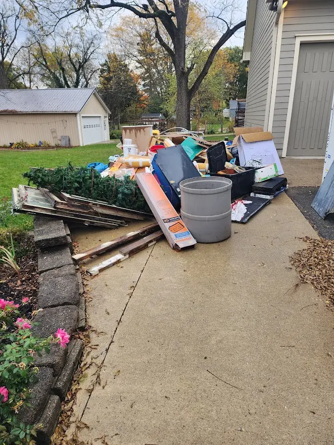Dumpster being loaded with debris for Demolition Dumpster Rental in Owasco